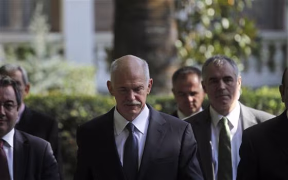 Greece's Prime Minister George Papandreou after meeting with Greek President Karolos Papoulias, in Athens on Saturday. Embattled Papandreou launched efforts to form a four-month coalition government, arguing the move is vital to demonstrating Greece's commitment to remaining in the eurozone.